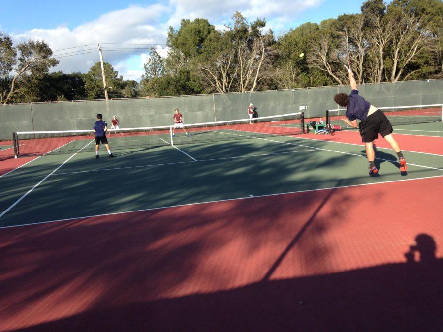 Freshman Ben Barde serves the ball in his doubles match as he and his teammate fight for the victory. 