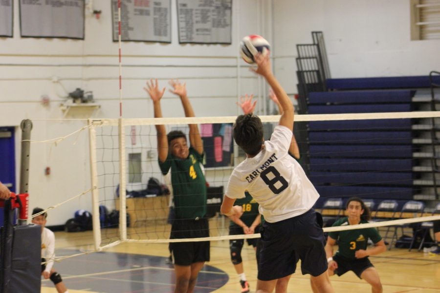 Adam Chin, a senior, hits the ball, earning a point for the Scots.