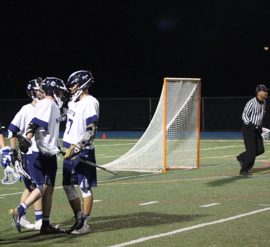  Jack Morris, a senior, gets congratulated by his teammates after his goal. 