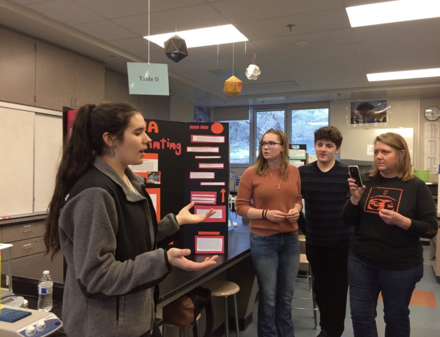 Sophomores+Tiara+Testa%2C+Jessie+Zorb%2C+and+Terby+Diesh+present+their+biotechnology+project+on+DNA+fingerprinting+to+a+group+of+parents.