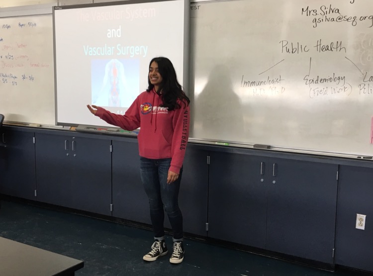 Club president Annika Nambiar presents about the vascular system and surgery to  members in science room C2.