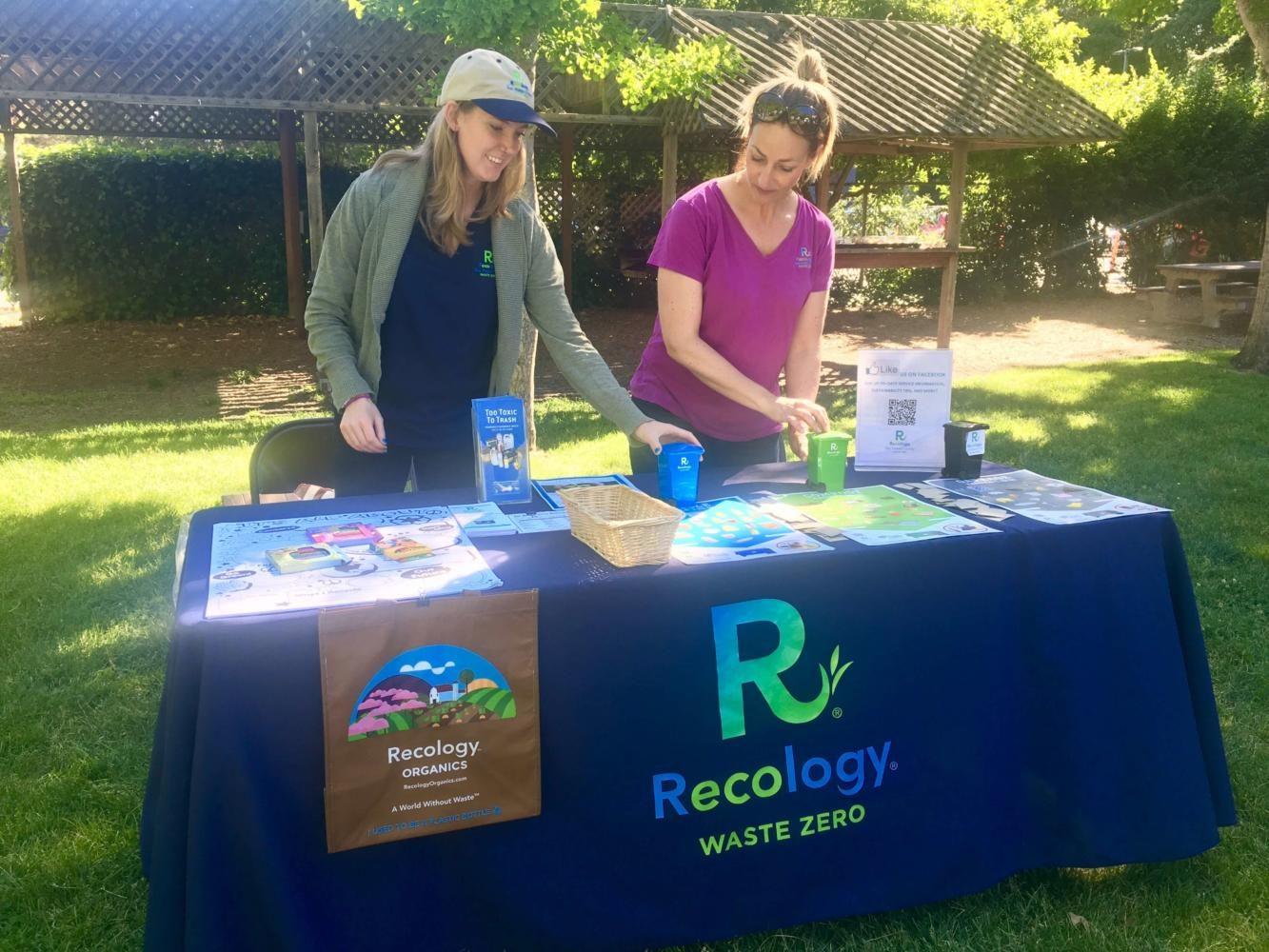 Gina Tretten and Rachael Lacey from Recology wait for people to stop by their booth. I hope people learn something new about what materials go into garbage, recycling, and compost bins, said Lacey.