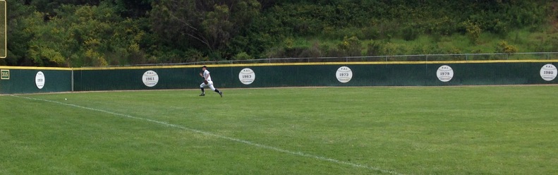 Ryan Huskey chases down a hard ground ball near the left-field foul pole. 