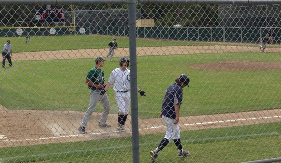 Ryan Busser (center) looks to third base coach Willie Baroncini after being stranded by a line drive.