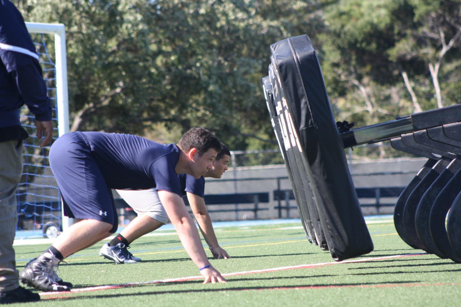 Varsity football players practice lineman drills after school on May 25.