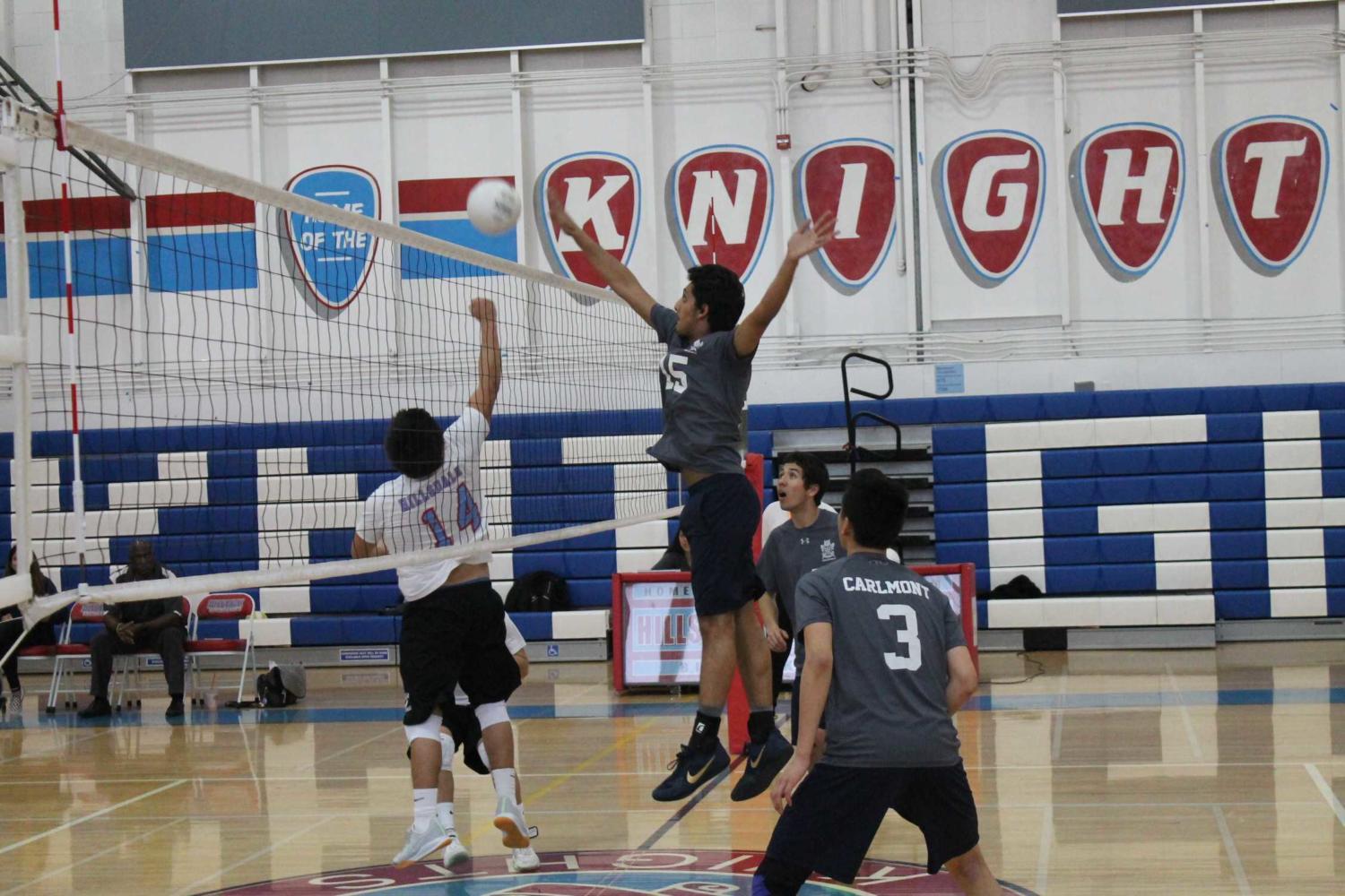 Kazmin Haider, a junior, hits the ball over the net to the Knights. 