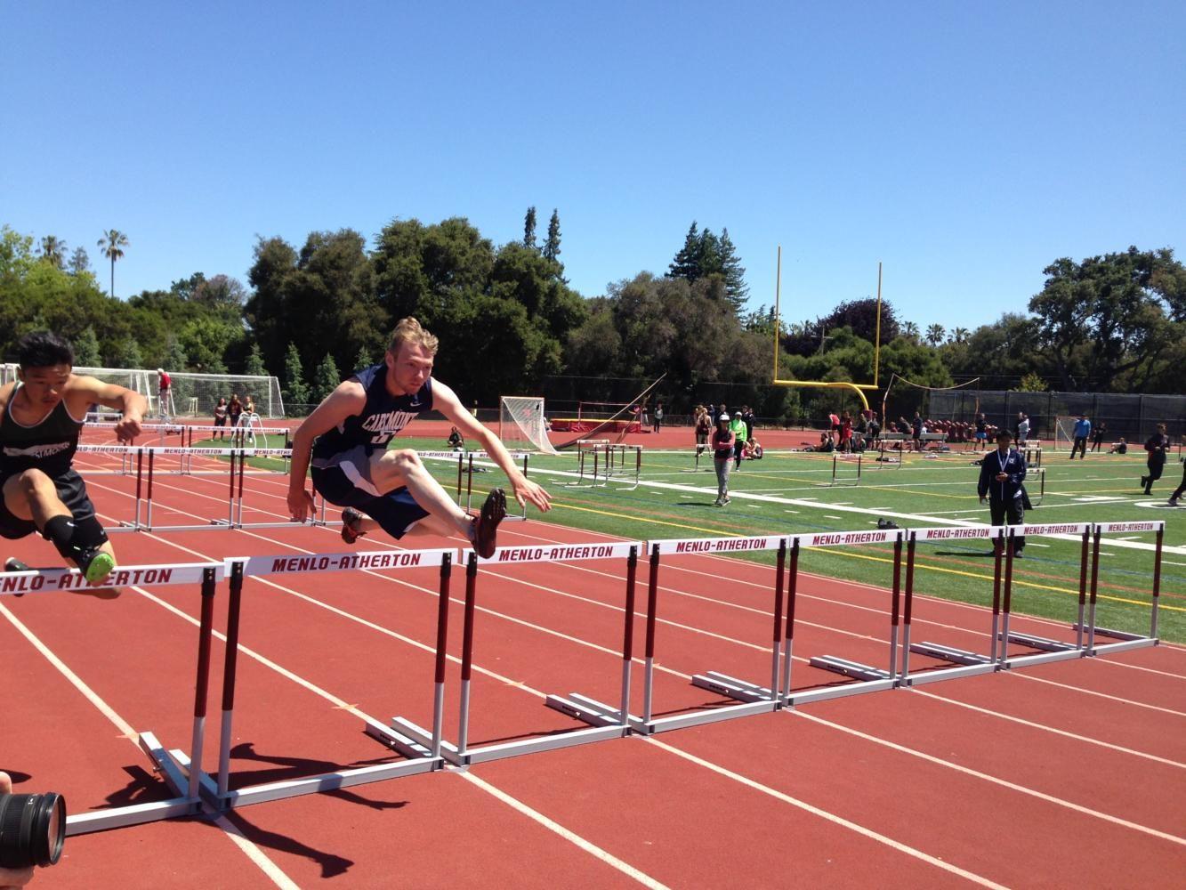 Victor Solyanik, a senior, tries to get ahead of his competitor. He would finish sixth in the 110m Hurdles. 