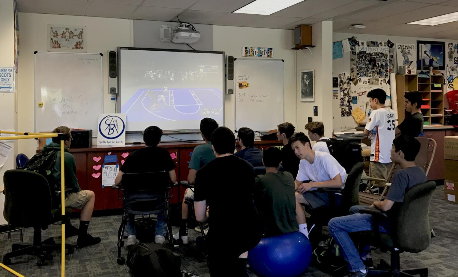 Student competitors and observers gather in the ASB room to watch a NBA 2k17 match.