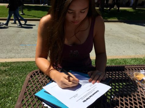 Maya Schwartz, a junior, signs up the girls tennis team for Carlmont Cup.