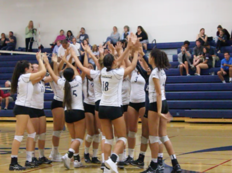 Scots cheer after winning the point in a long rally against the San Mateo Bearcats.