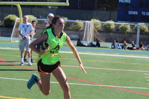 Emma Castro runs the ball down the field in one of last years powder puff games. In previous years, powder puff took place at lunch during homecoming week. 