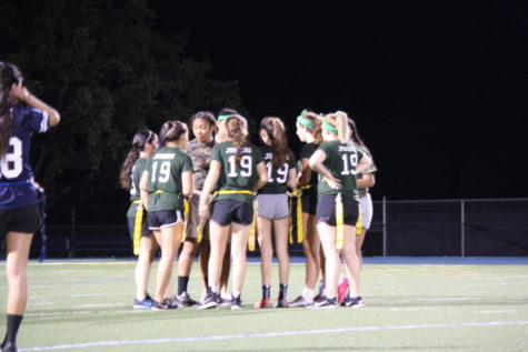The junior team gathers for a huddle during the Powderpuff game this year against the seniors. 