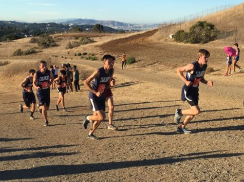 Caleb Ahn and Sam Holbrook, both juniors, make their way up the first hill at the Crystal Springs Course.