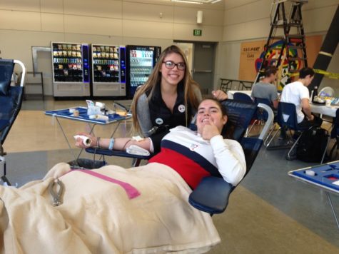 Lizzy Hall, a junior, gives blood at the Blood Drive.
