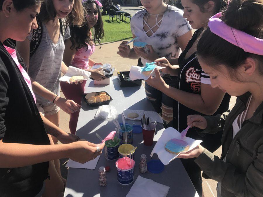 Students line up in the quad to add frosting and sprinkles to their cookies.