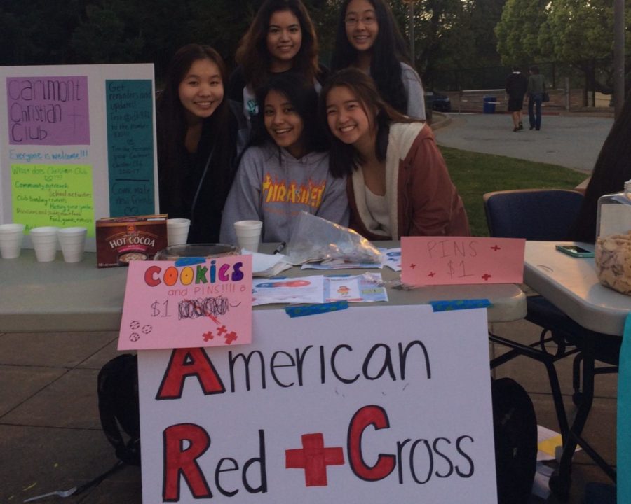Red+Cross+Club+members+have+their+station+set+up+at+the+club+fair.+They+promoted+the+importance+of+getting+vaccinated+by+selling+pins+to+the+student+population.+