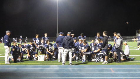 The JV team gathers around Head Coach Bruce Douglas after the game.
