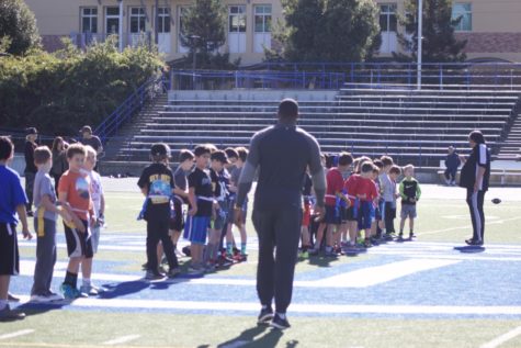 Players gather at Carlmont High Schools field for a flag fooball clinic, with special guest NFL tight end Kevin Greene.