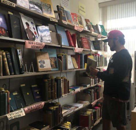 A man shops for a book during the monthly used book sale at the San Carlos  Public Library. 