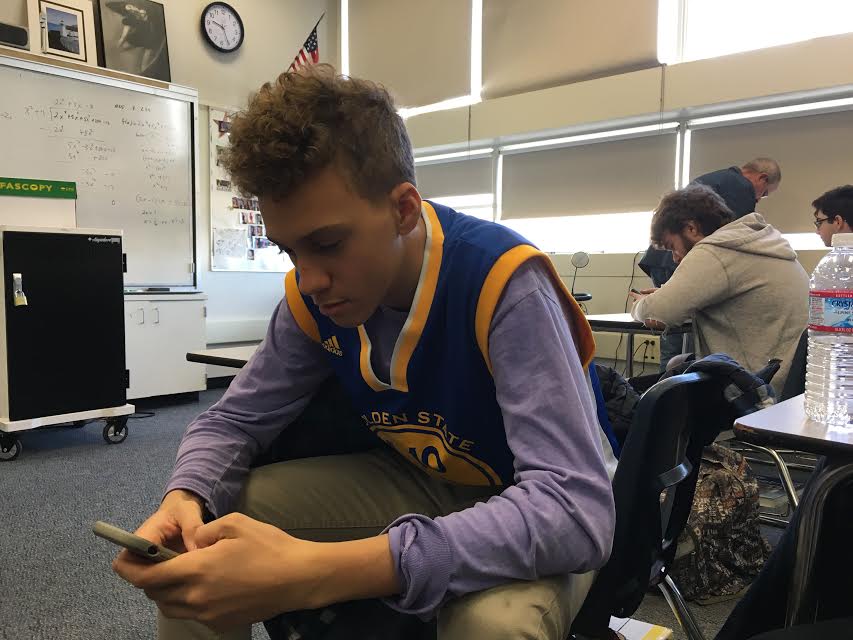 Zachary Kuchlenz, a junior and a Warriors fan, wears his teams colors in math class.