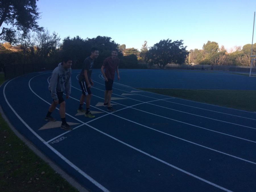Three cross country runners are shown preparing to start their daily after-school run.