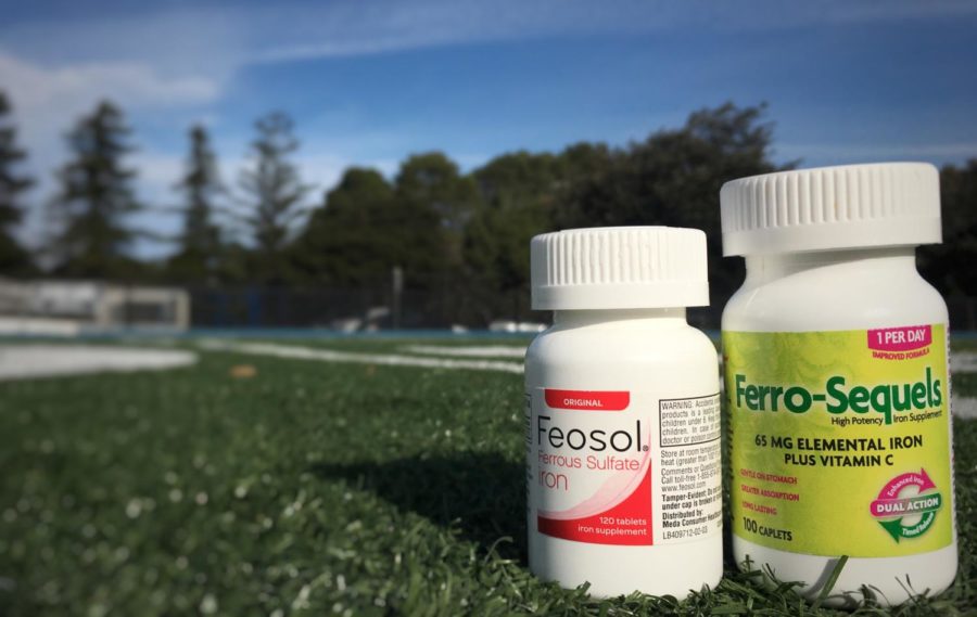 The iron supplements Allie Ayers takes in order to keep her levels of iron stable are positioned on the soccer field at Carlmont High School, where Ayers realized something was keeping her running from improving. She eventually learned that she was severely anemic.