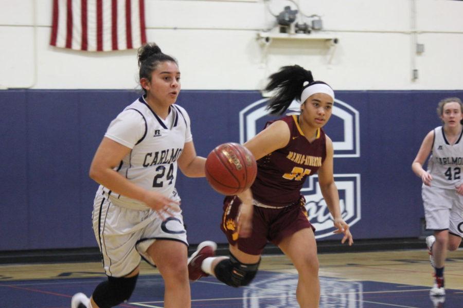 Junior Izzy Rodriguez tries to outrun a Menlo Atherton player while looking for an open player to pass to.