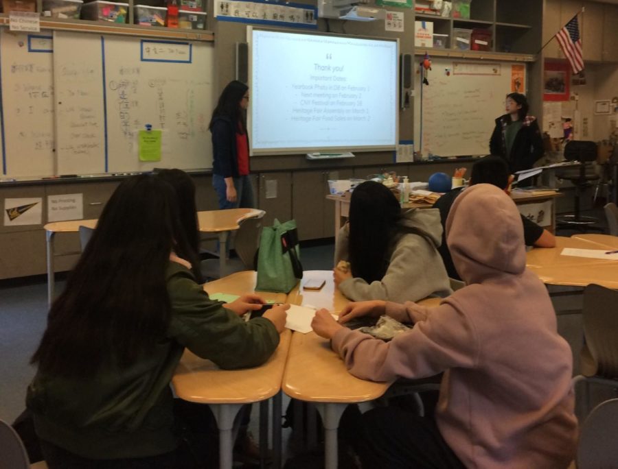 A group of students listen to a presentation in Chinese Culture Club
