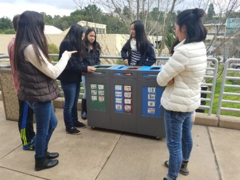 The Green Team stands outside during one of their meetings and discusses the tri-bin system.