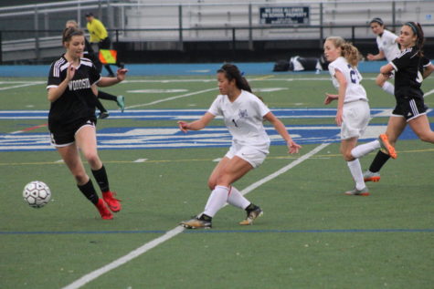 Samantha Phan, a junior, fights for the ball with hopes of scoring for the Scots.
