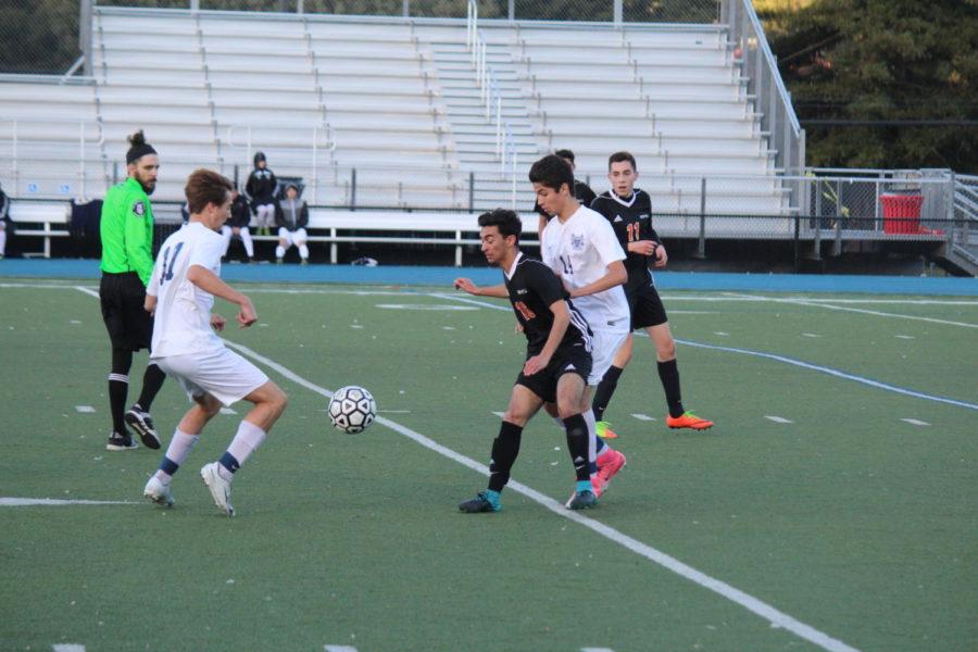 Defender Antonio Barba steals the ball away from Woodside forward.
