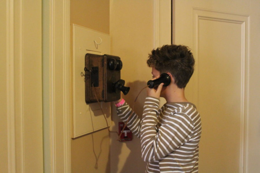 Visitor Charlie Baker uses the telephone located at the back of the Filoli house.