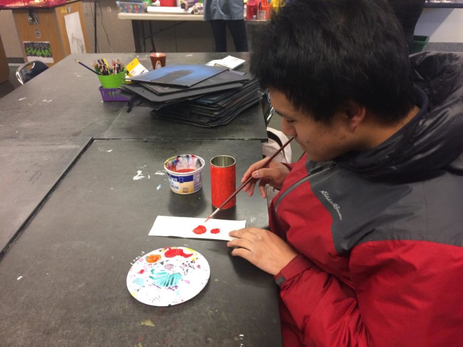 Jonathan Yip, a senior, puts the finishing touches on his very own hand made candle.