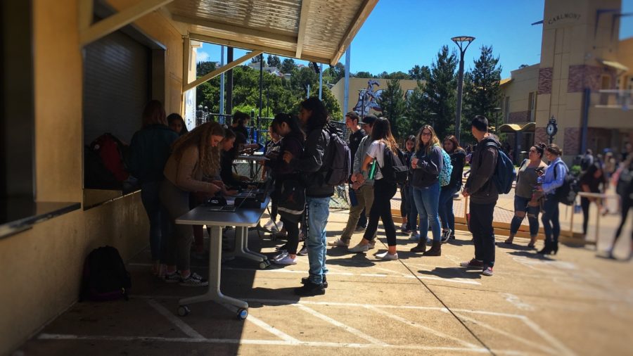Students eagerly await their turn to purchase tickets for prom in the quad.