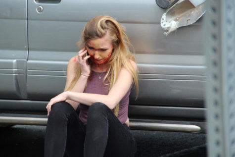 Jessica Cramer, a senior, calls 911 in a panic during the drunk-driving car crash simulation on April 15.
