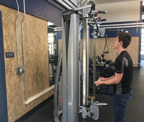 Ethan Stroh, a senior in Weight Training Club, works out in the Carlmont weight room.