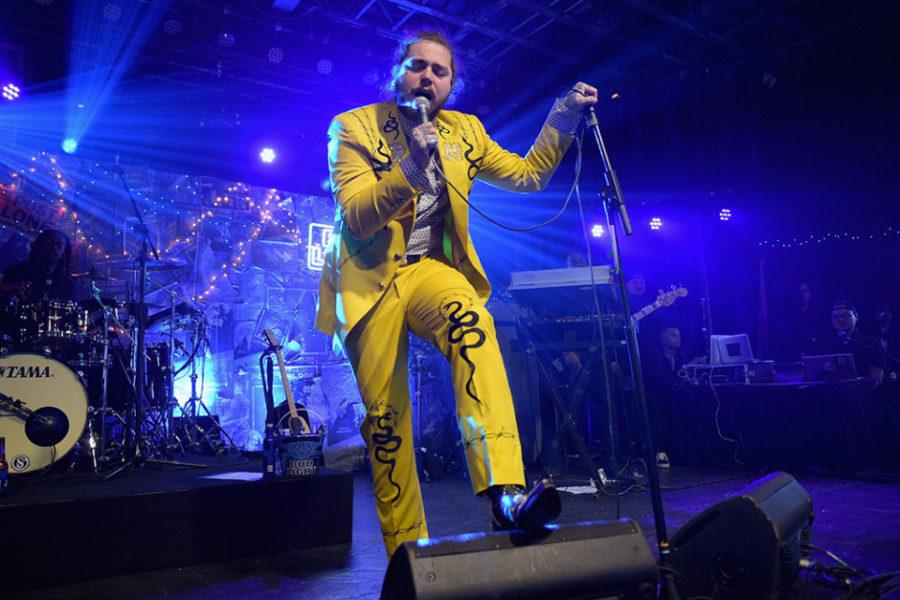 Post Malone debuts his new album, beerbongs & bentleys, with yellow attire to match the album cover.
