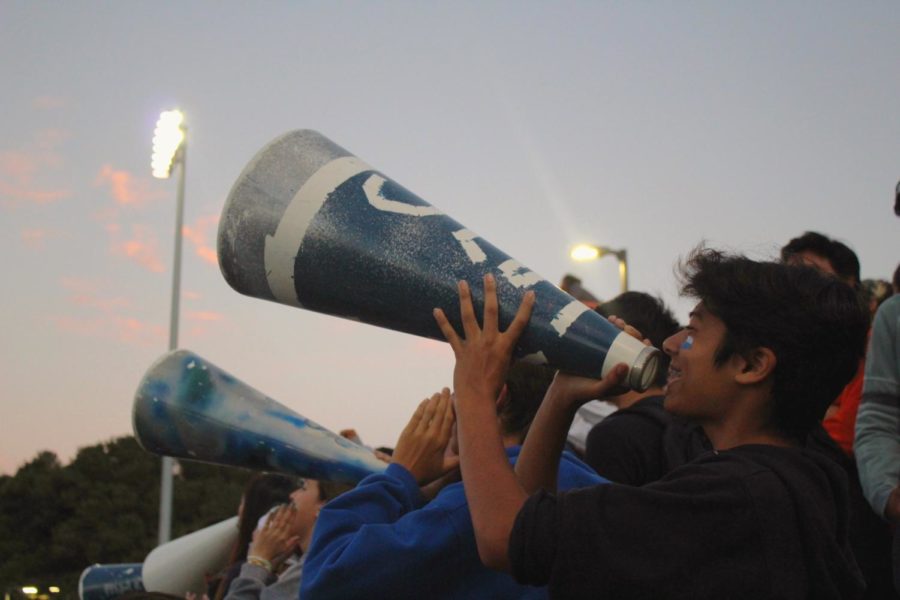 The Screamin Scots use megaphones to cheer for the football team and raise spirit.