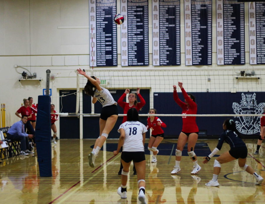 Sophomore Leah McMillen jumps to get a kill against the Burlingame Panthers.