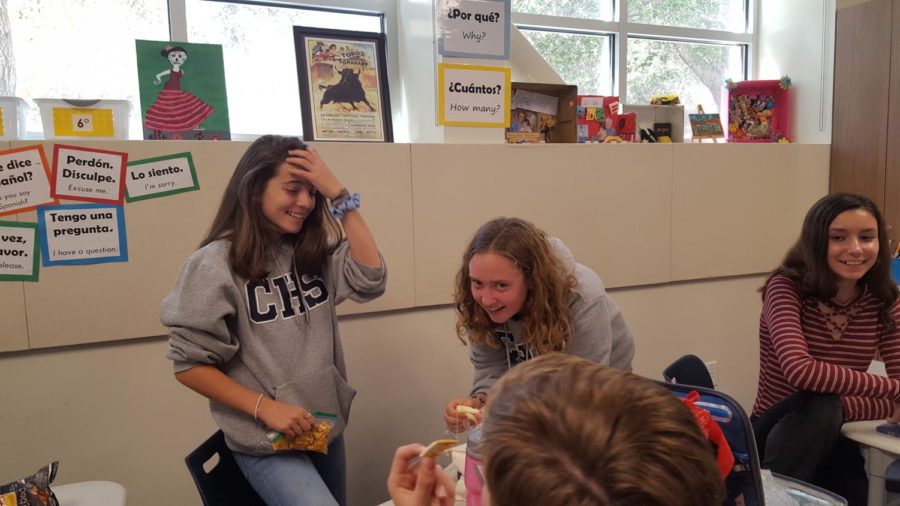Freshmen, Isabella Peterson (left), and Tori Balsam-Ashling (right), laugh about an old song that was being played.