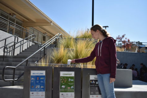 Alice Chamberlin, a junior, uses the tri-bins to throw her thrash away. With the tri-bins now on campus, many students are eager to throw their trash away in the correct spot.