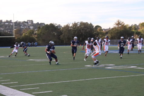 Running Back Dane Fifita, a freshman, puts a move on a Woodside defender, fighting for extra yards.