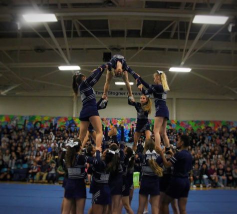 Carlmont cheer shows off one of their new stunts in the homecoming assembly.