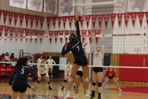 Alisha Mitha, a junior, spikes the ball against the Burlingame Panthers in the fifth set.