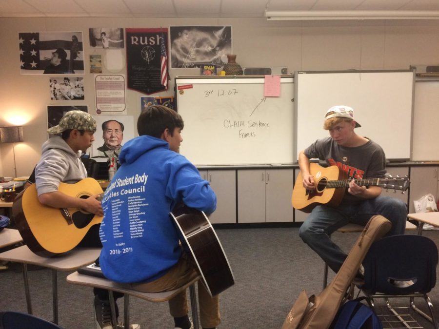 Members of the Guitar Club jam together during lunch in E7.