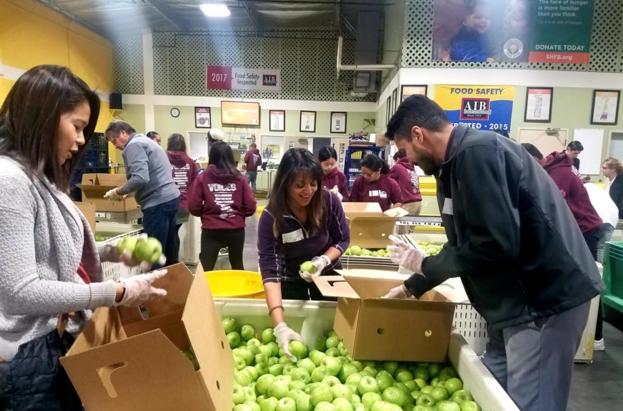 Volunteers at the latest event sorted apples for families for the holiday season. 