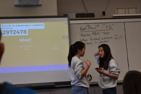 Selena Sun, a junior, and Denise Zhou, a junior, discuss club progress.