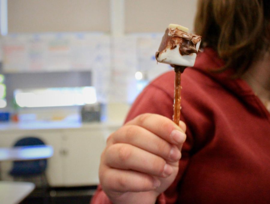 Sophomore Jessica Nepomnyshy holds up a candy dreidel made of marshmallow, pretzel, Nutella, and white chocolate chips.