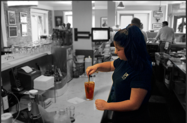 Emma Weitz, a sophomore, prepares a drink for a customer during her shift at Farm House Restaurant in Belmont. 