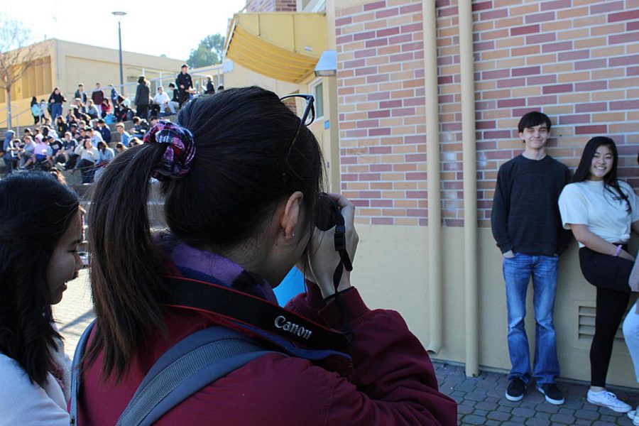 Lauren Chong takes a club photo for the yearbook in the quad.